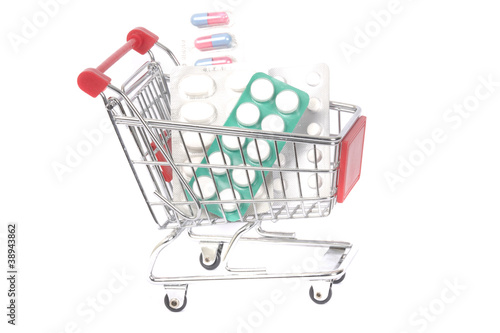 Capsules in shopping cart trolley for healthy concept