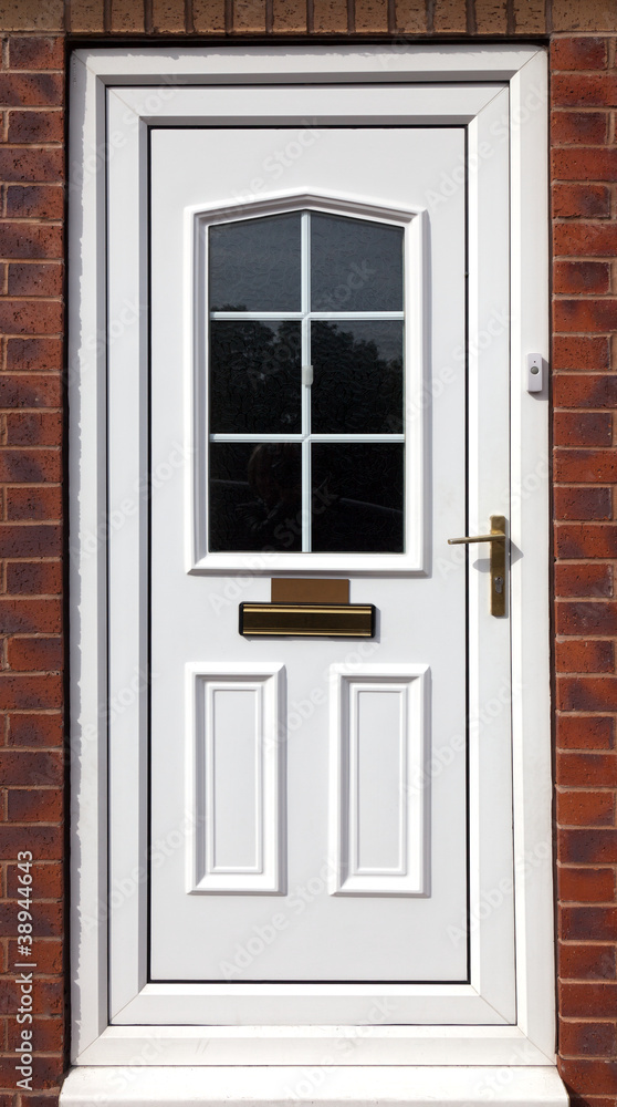 white front door in a red brick  building