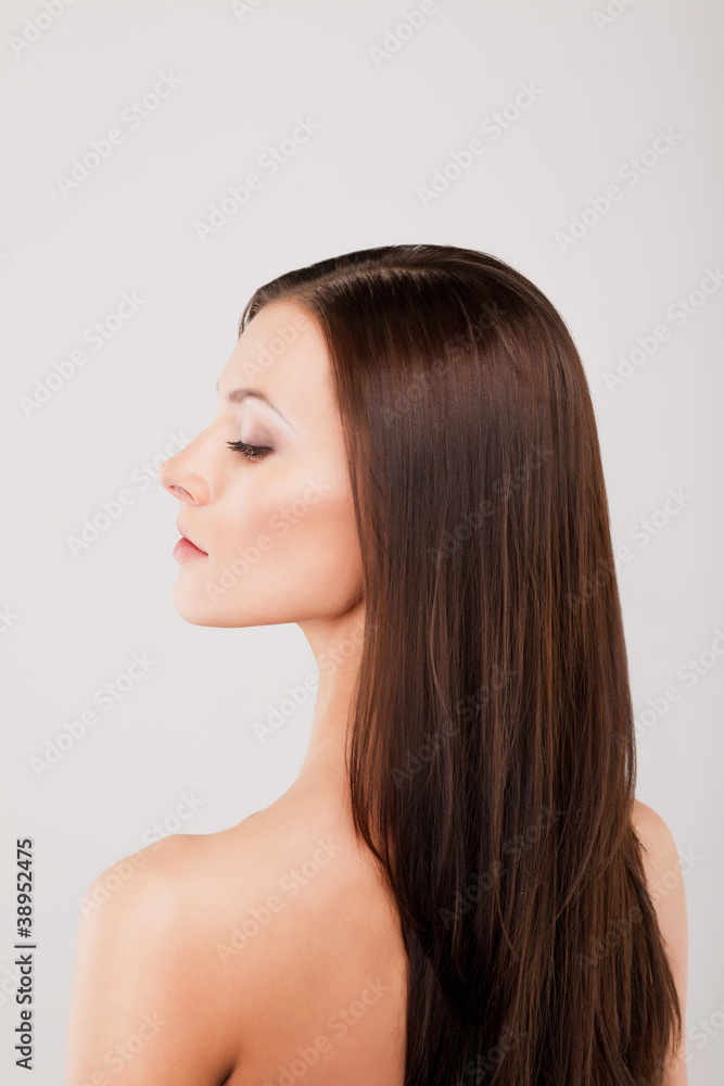 Beautiful young woman's face with healthy clean skin in profile Beautiful young woman's face with healthy clean skin in profile