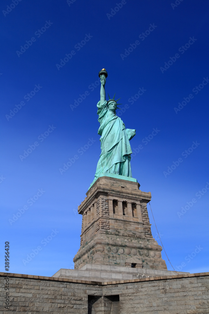 Fototapeta premium The Liberty Statue with clear blue sky sunny day, New York