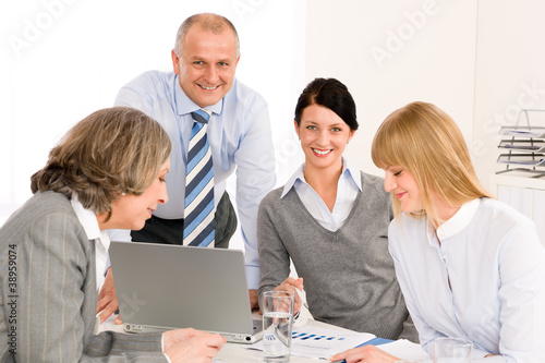 Business team meeting people around table