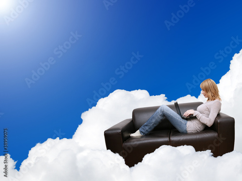 woman relaxing with laptop in couch on the cloud