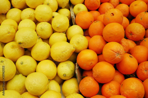 lemons and clementine on market stand