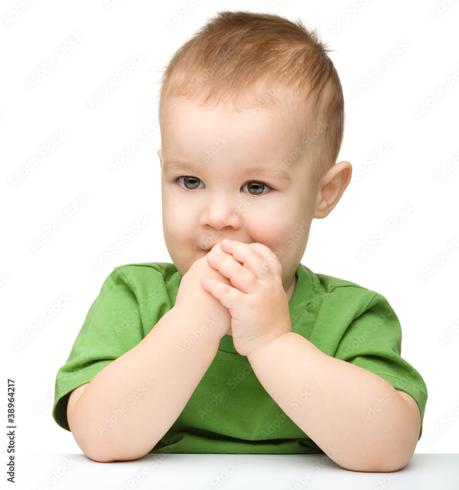 Pensive little boy support his head with hand Pensive little boy support his head with hand