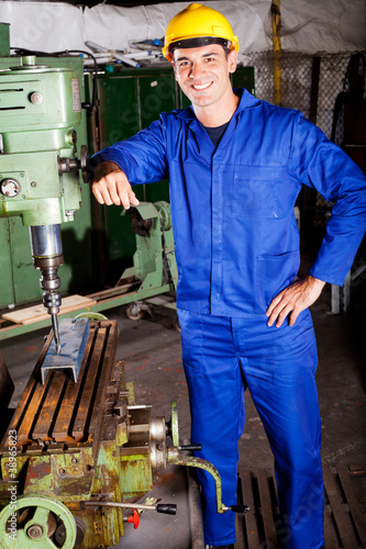 portrait of industrial machinist inside workshop photo