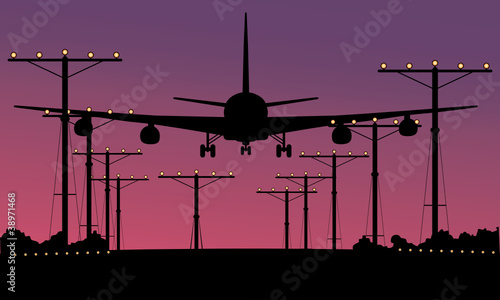 Airliner landing at sunset