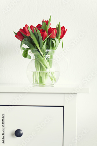 beautiful red tulips on a white table