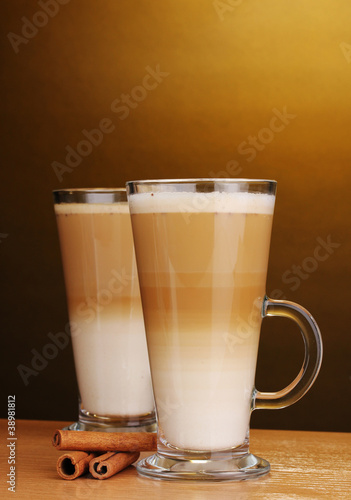 Fragrant сoffee latte in glass cup and cinnamon