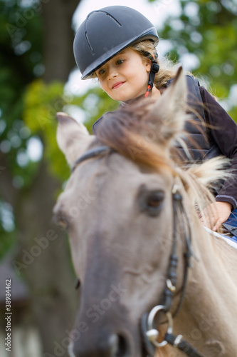 Horse riding - little girl is riding a horse © Gorilla