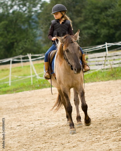 Horse riding - lovely girl is riding a horse © Gorilla