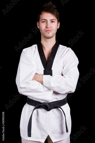 Portrait of young martial arts man on black background