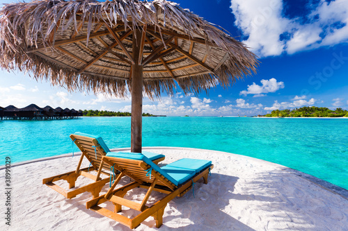 Fototapeta Naklejka Na Ścianę i Meble -  Two chairs and umbrella on tropical beach