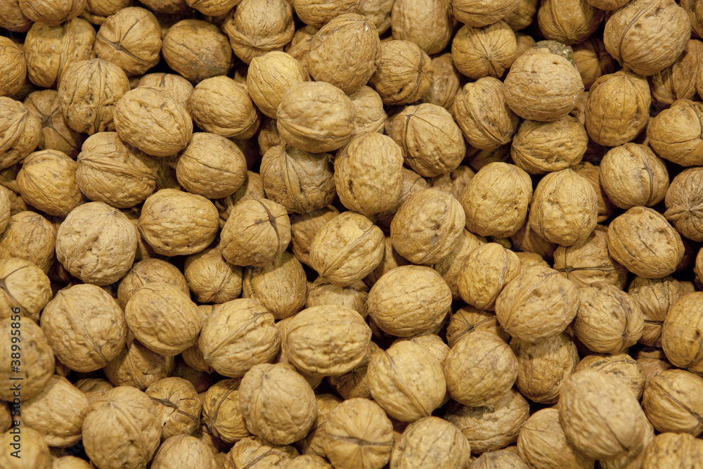 Pile of walnuts forming a background Pile of walnuts forming a background