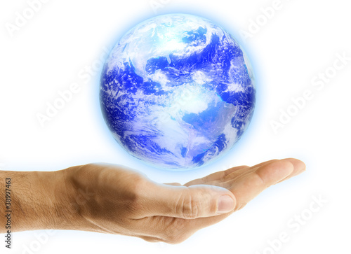 Glowing blue earth in a hand on white background