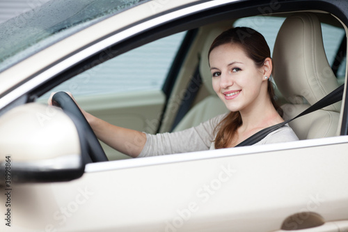 Pretty young woman driving her new car © lightpoet