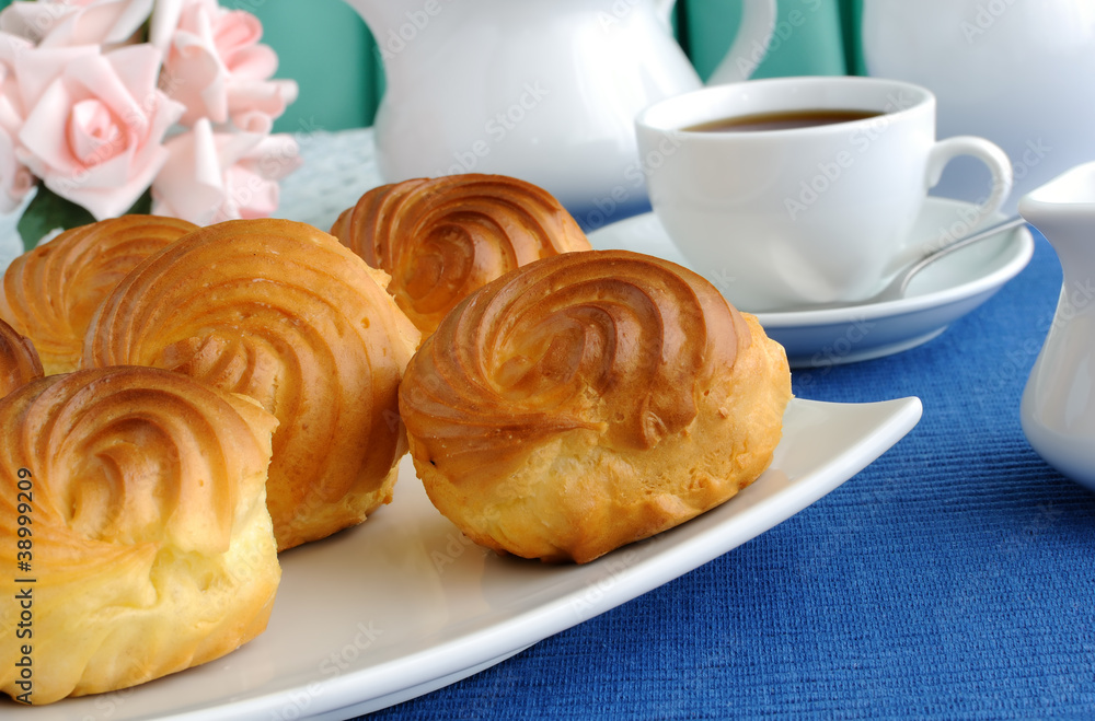 Eclairs with a cup of coffee