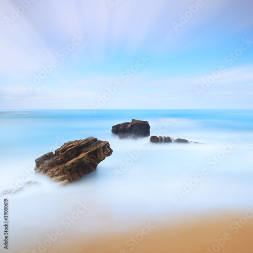 Three rocks seascape. Long exposure photography.