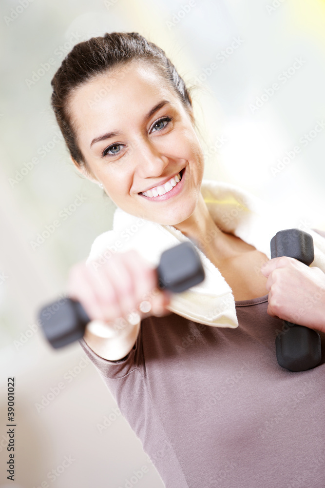 dumbbell in hand of working out young smiling female dumbbell in hand of working out young smiling female