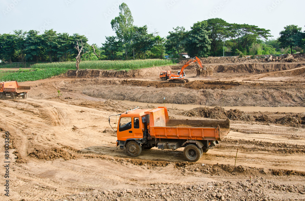 Heavy excavator loader at soil moving works at construction site Heavy excavator loader at soil moving works at construction site