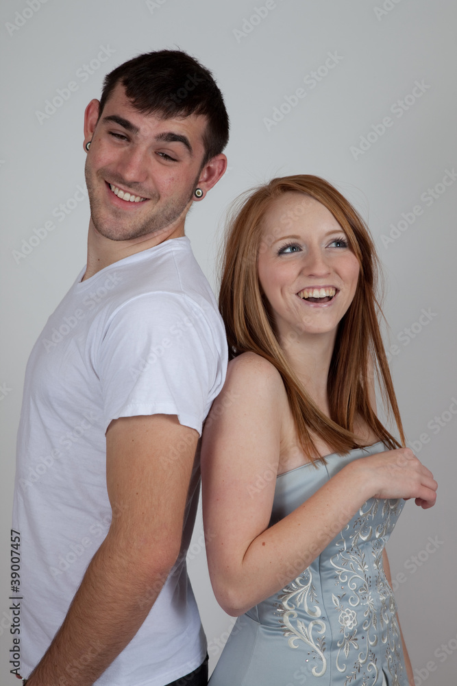 couple standing back to back and laughing couple standing back to back and laughing