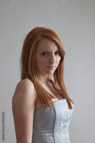 Redhead woman looking seriously at the camera