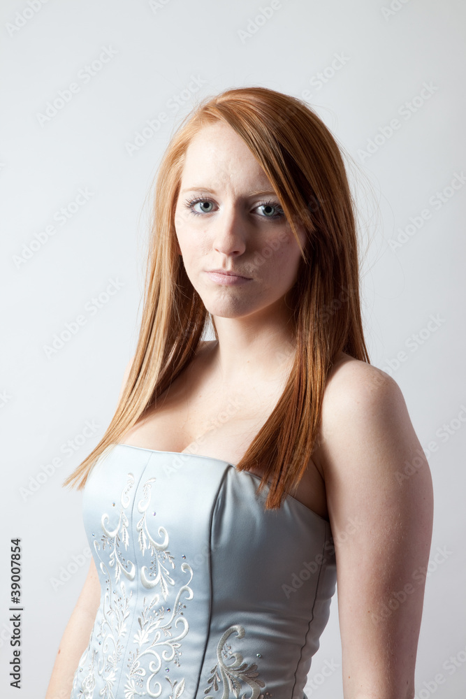 Redhead woman looking seriously at the camera Redhead woman looking seriously at the camera