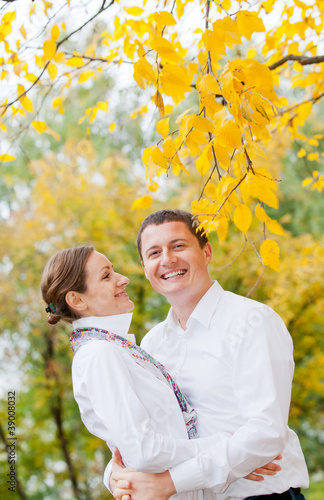 Romantic young beautiful couple on autumn walk