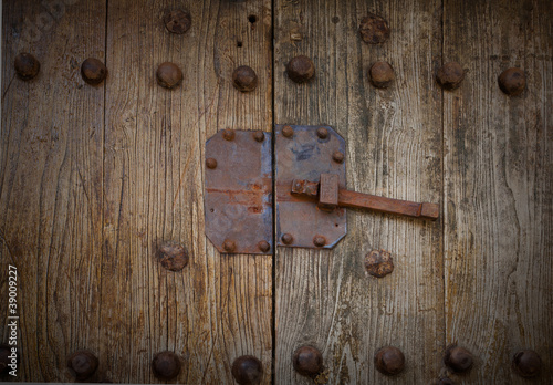 rusty lock on wooden door