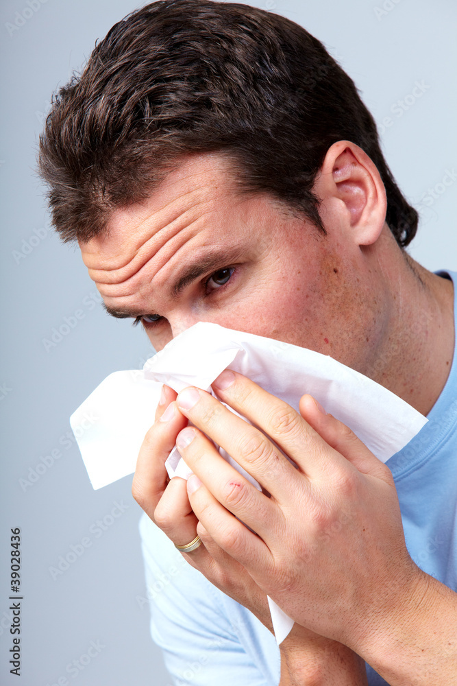 Sneezing man having cold. Sneezing man having cold.