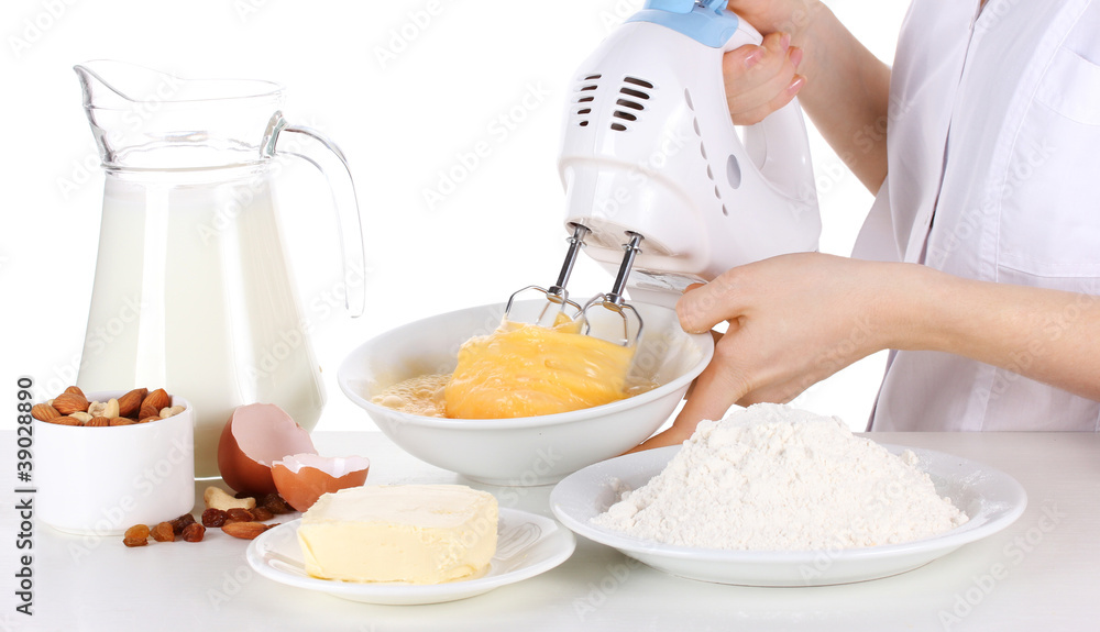 Female hands mixing eggs in bowl isolated on white Female hands mixing eggs in bowl isolated on white