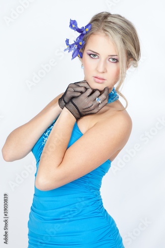 Beautiful blond woman in elegant blue dress with blue flowers