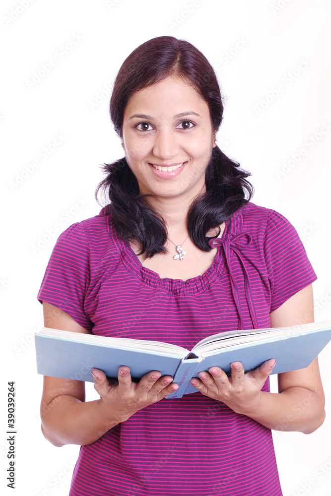 Smiling young Indian student with her book in hand Smiling young Indian student with her book in hand