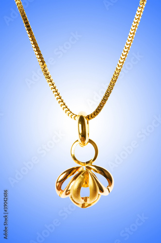 Golden jewellery against gradient background