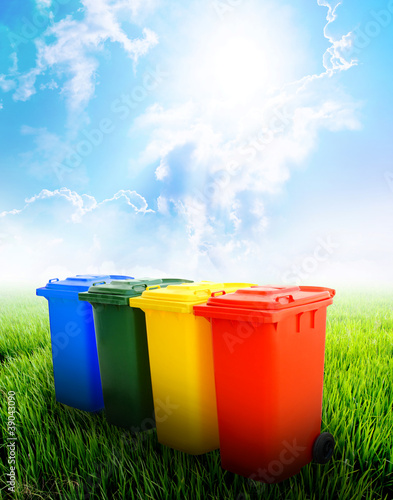 Colorful recycle bins with landscape background