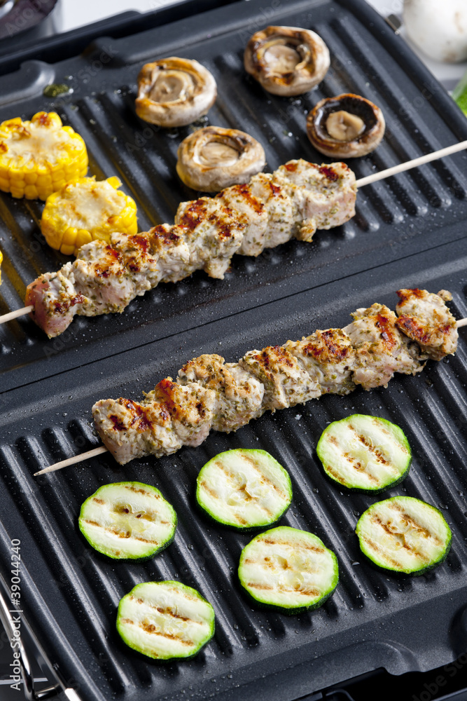 meat skewers and vegetables on electric grill meat skewers and vegetables on electric grill