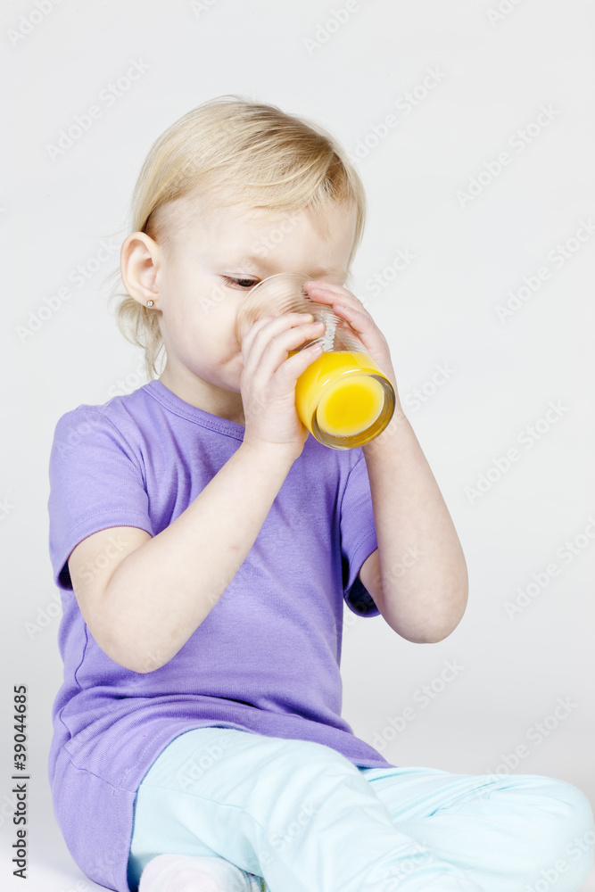 portrait of little girl drinking orange juice portrait of little girl drinking orange juice