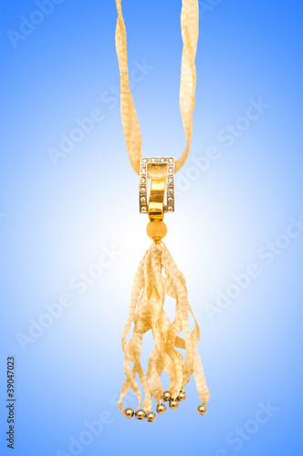 Golden jewellery against gradient background