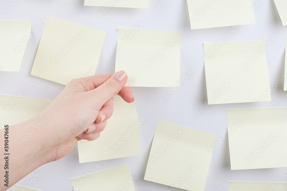 Hand holding sticky note Hand holding sticky note