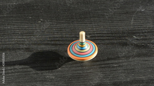 colorful wooden whirligig on the old black table