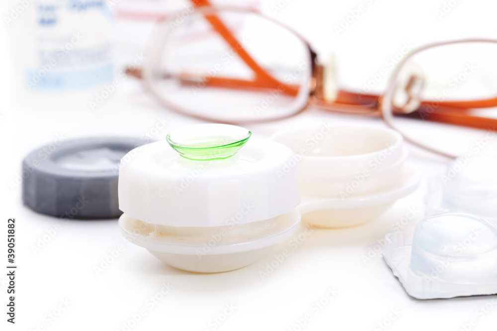 Close-up of green contact lenses in container with solution. . Close-up of green contact lenses in container with solution. .