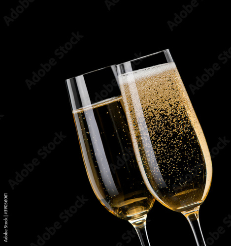 Champagne pouring in to a glass on a black background