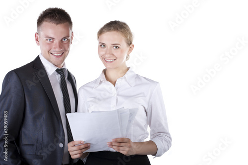 Two businesspeople sitting at table and writing