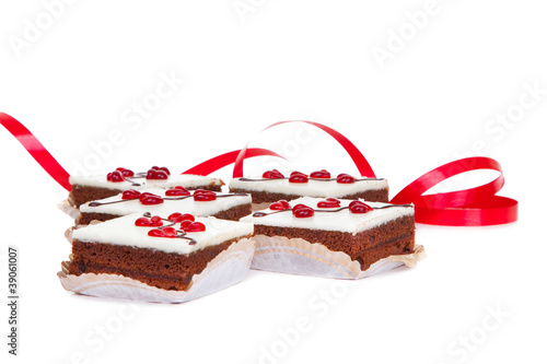 cakes with jelly hearts and red ribbon on isolated white