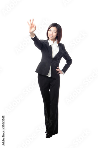 Perfect business woman showing OK hand sign in full length