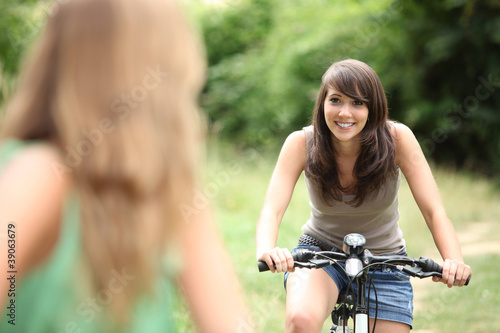 Two teenage girls on bike ride