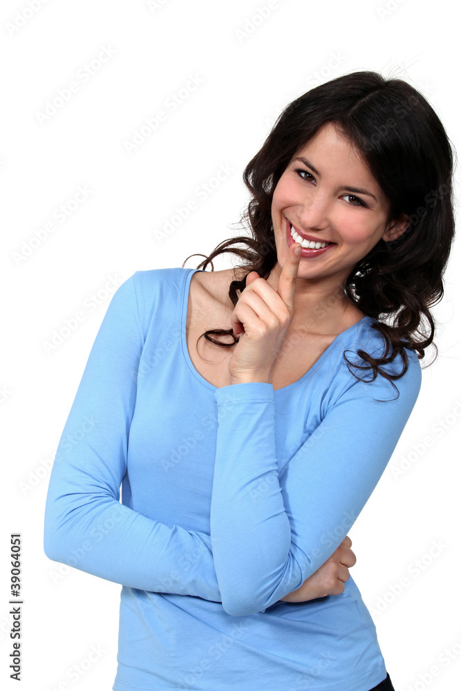 Woman with her index finger to her lips Woman with her index finger to her lips