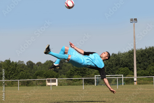 Footballer in mid-air back kick