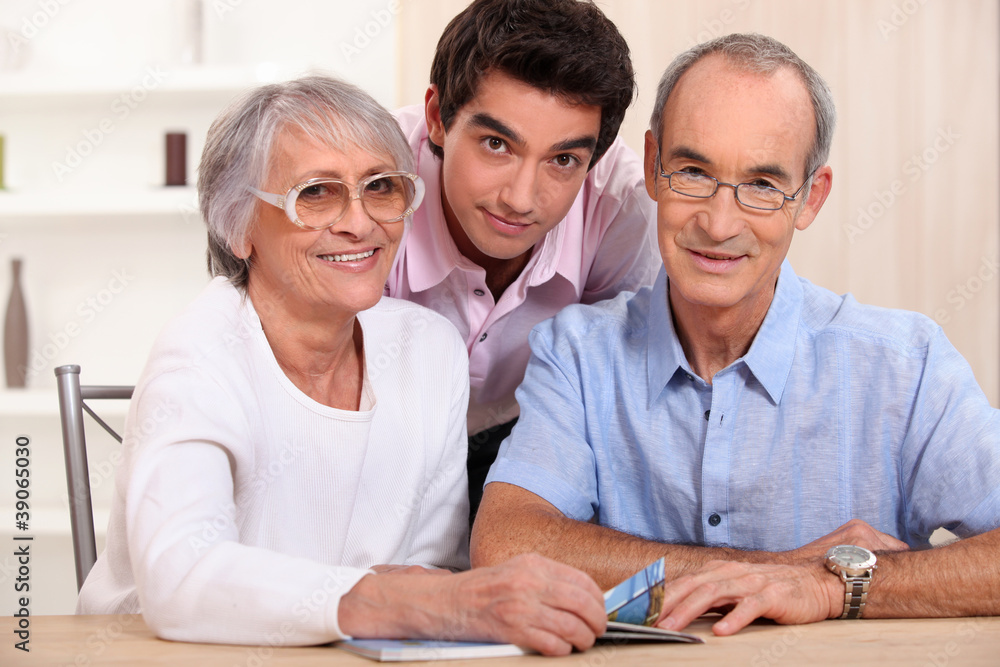 Fototapeta premium Grandson posing with his grandparents