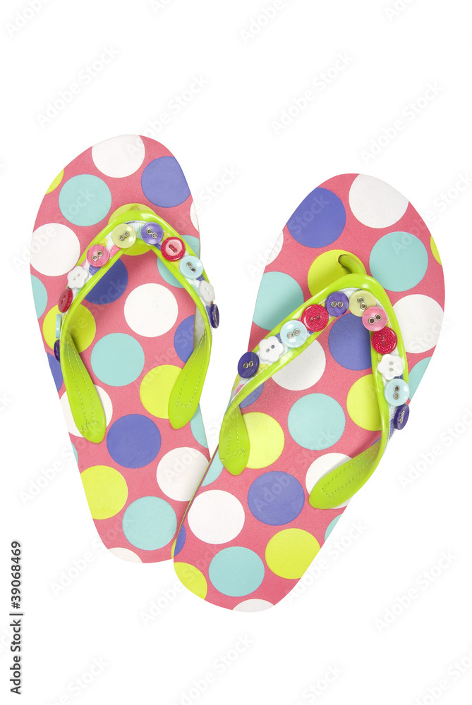 Pair of spoted flip flops on white, clipping path included Pair of spoted flip flops on white, clipping path included
