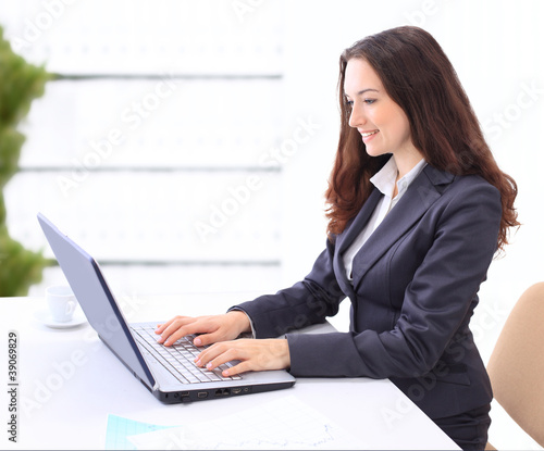 Thoughtful business woman in the office for a laptop